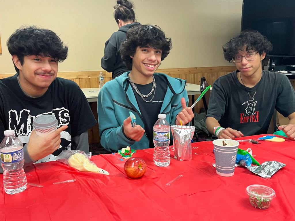 Brothers Hector, Luis, and Micah enjoying a snack at Camp Catch-Up.